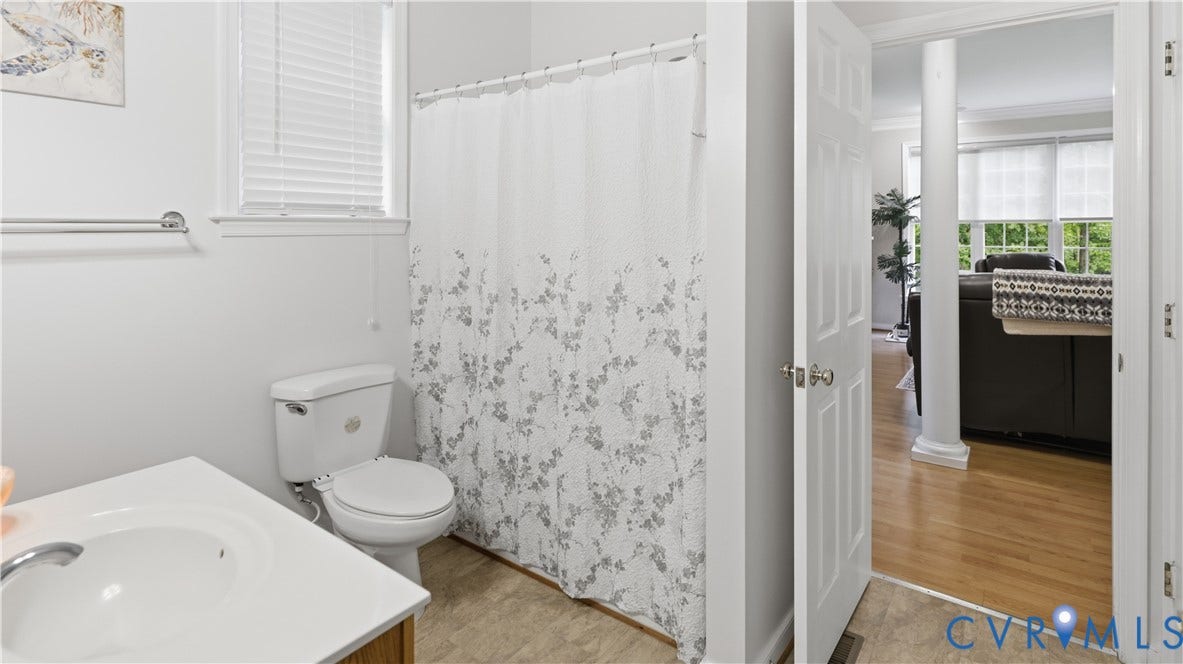 1836 Rocky Ford Road, Powhatan, VA 23139 Bathroom featuring a vanity with an integrated sink, a toilet, and a window with blinds