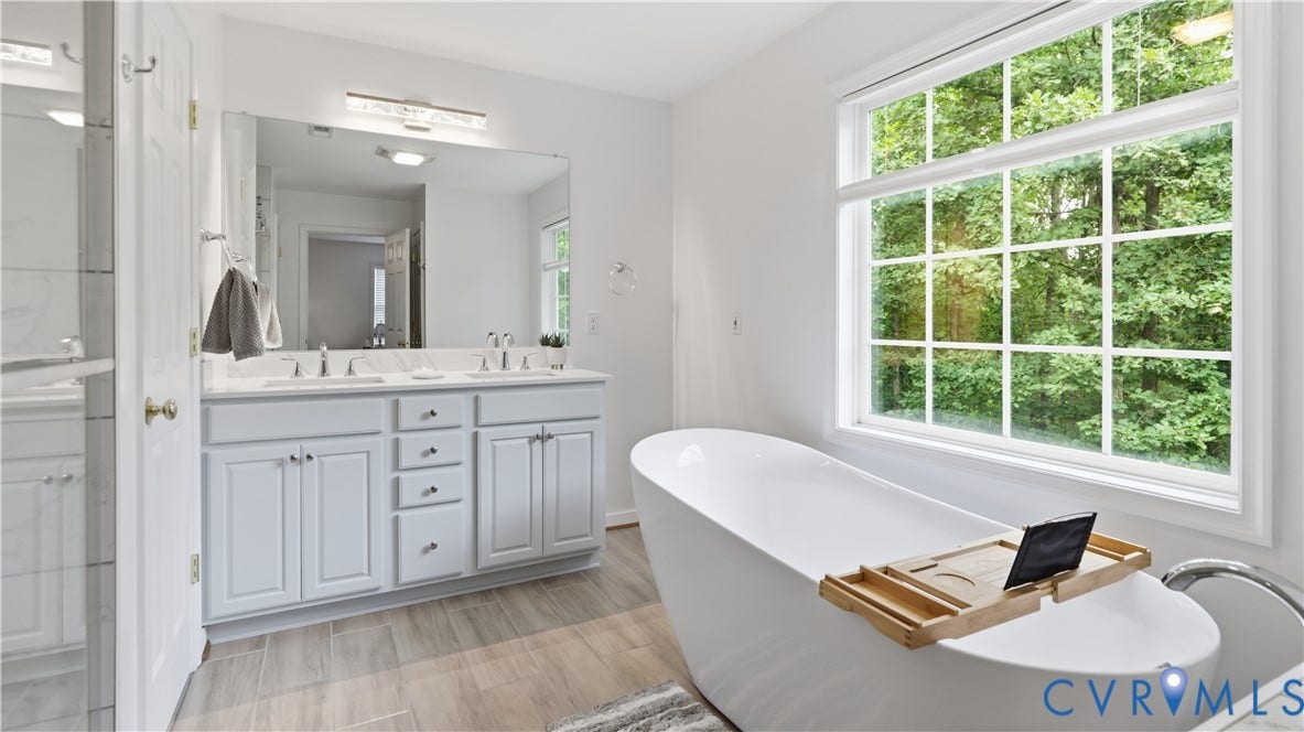 1836 Rocky Ford Road, Powhatan, VA 23139 Freestanding soaking tub with a large grid window overlooking greenery