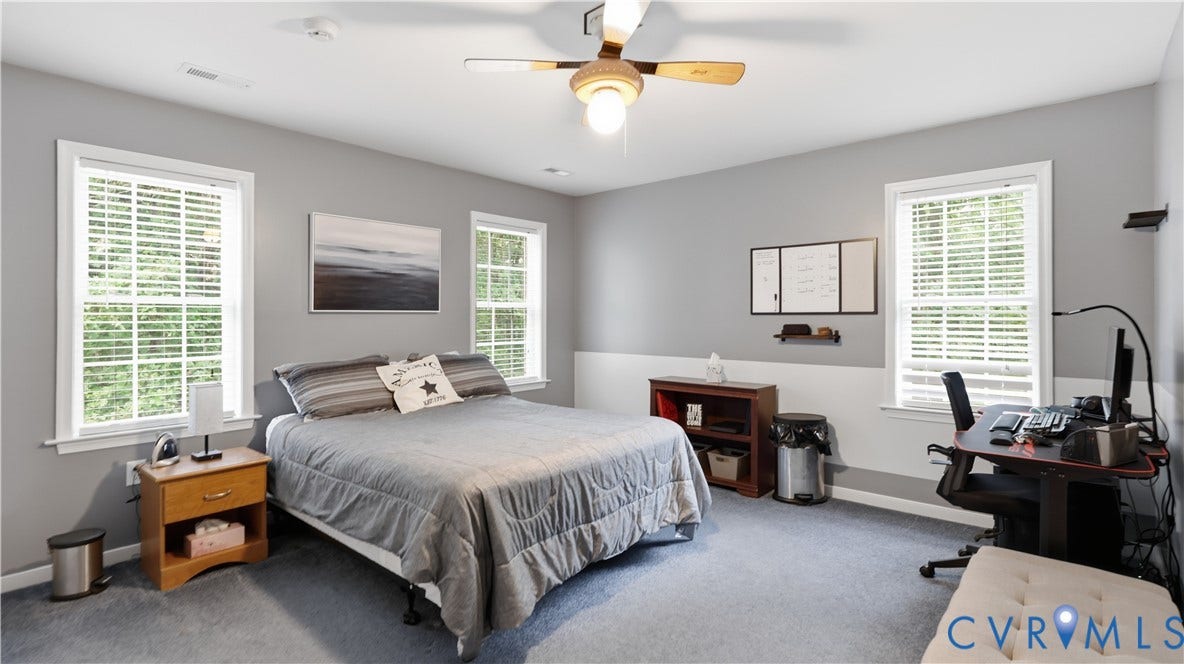 1836 Rocky Ford Road, Powhatan, VA 23139 Spacious bedroom with light gray walls, white trim, and light blue carpet flooring
