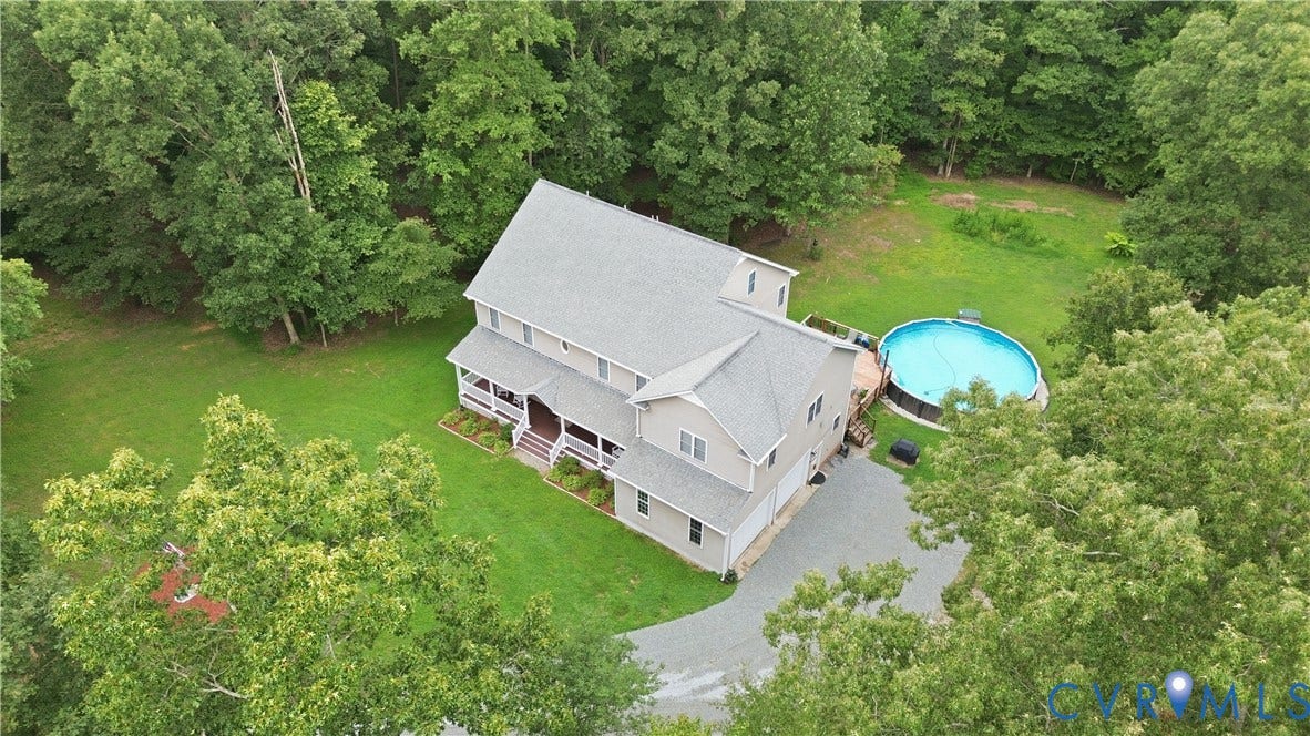 1836 Rocky Ford Road, Powhatan, VA 23139 Three-story residence with vinyl siding and a prominent front porch