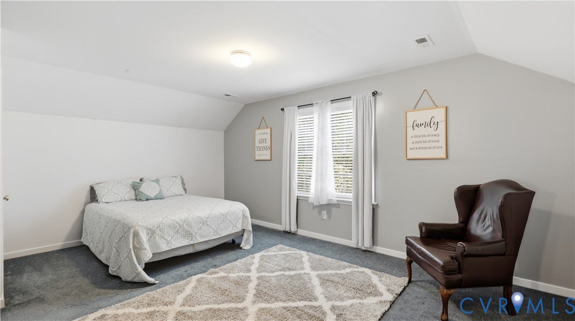 1836 Rocky Ford Road, Powhatan, VA 23139 Spacious room on the third floor featuring vaulted ceilings, multiple windows with blinds and sheer curtains, gray wall paint, and dark gray carpeting