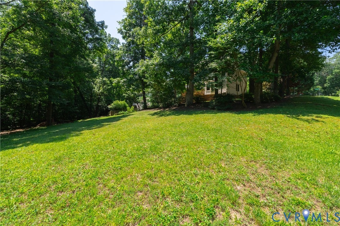 Expansive lawn bordered by mature trees