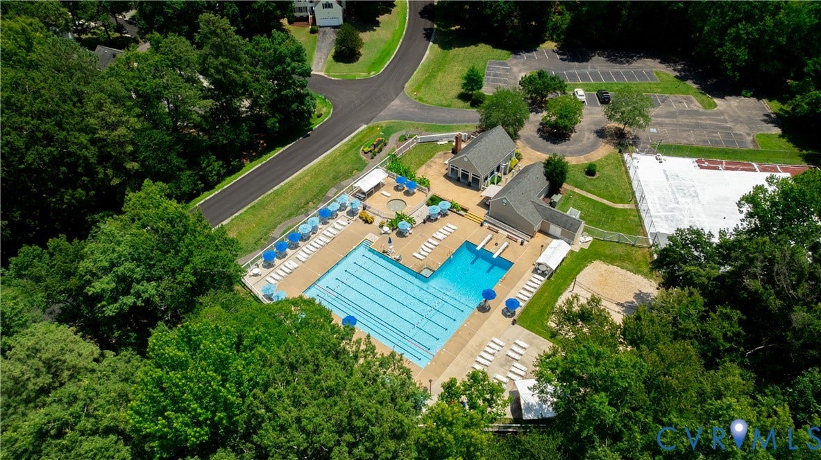 Community recreation area featuring a large swimming pool, a smaller wading pool, and sun loungers