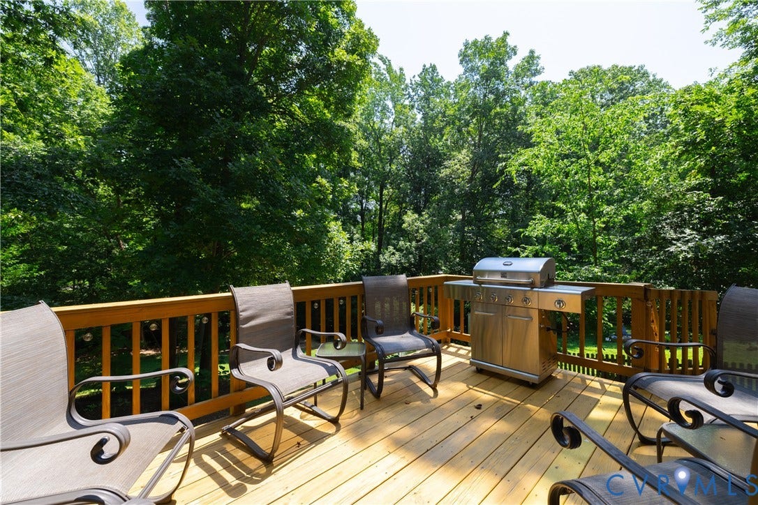 Spacious outdoor wood deck with a natural wood railing