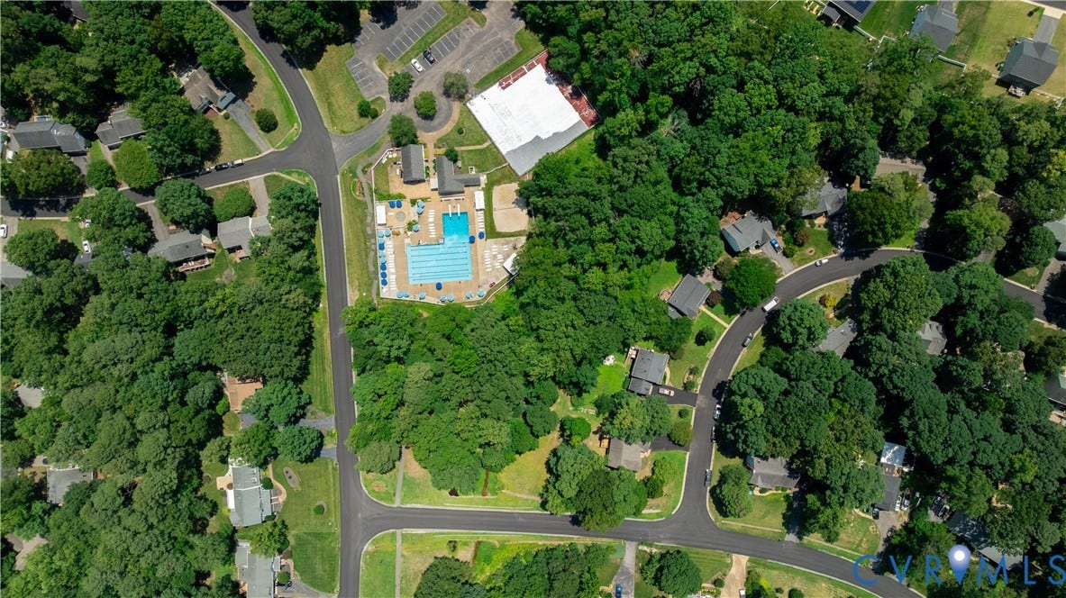 Aerial perspective showcasing a community with mature tree coverage and residential structures