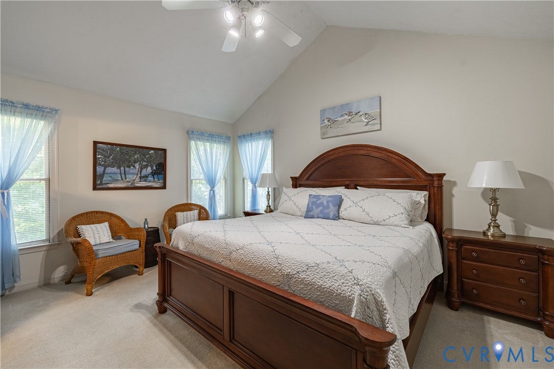 Room featuring a vaulted ceiling and light-toned wall paint