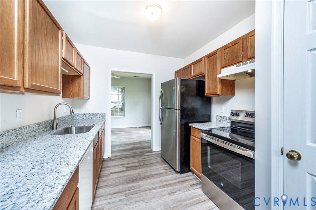 2802 Goyne Terrace, Chester, VA 23831 Kitchen featuring wood-finish cabinetry, granite-style countertops, stainless steel sink with gooseneck faucet, full-size electric range, and wood-finish flooring