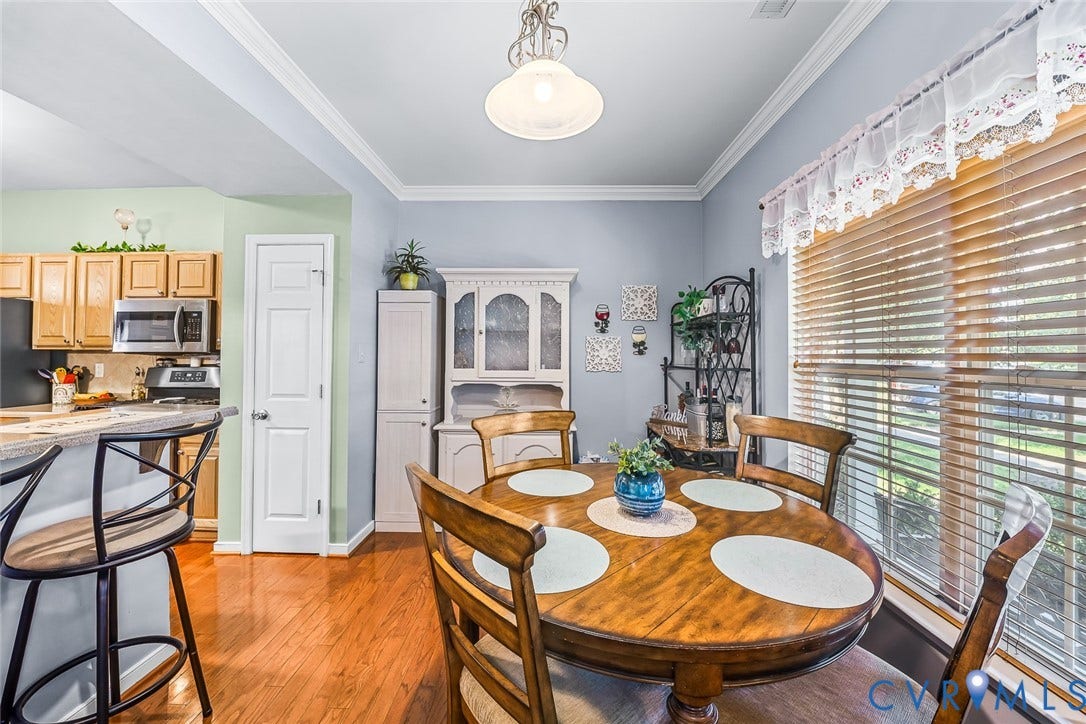 958 Wellston Court, Glen Allen, VA 23059 Dining area featuring wood-finish flooring, a large window with horizontal blinds, decorative crown molding, and a built-in hutch