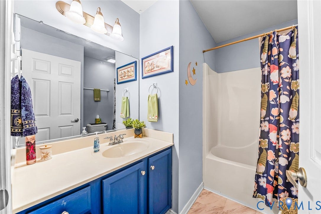 958 Wellston Court, Glen Allen, VA 23059 Bathroom featuring a single-sink vanity with a light-colored countertop and dark blue cabinetry