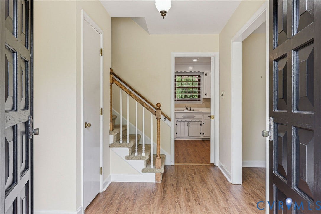 3737 Perthshire Lane, Colonial Heights, VA 23834 Entryway from the front door featuring wood-finish flooring, view to the kitchen, and stairs to the third level