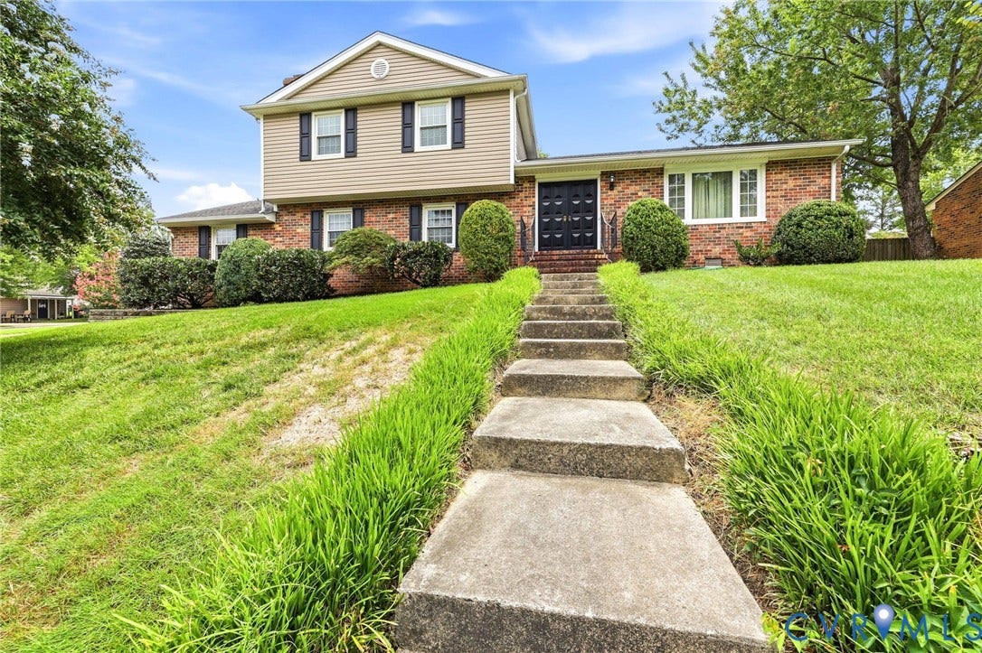 3737 Perthshire Lane, Colonial Heights, VA 23834 Split-level home featuring a brick and siding exterior, concrete walkway, and established landscaping