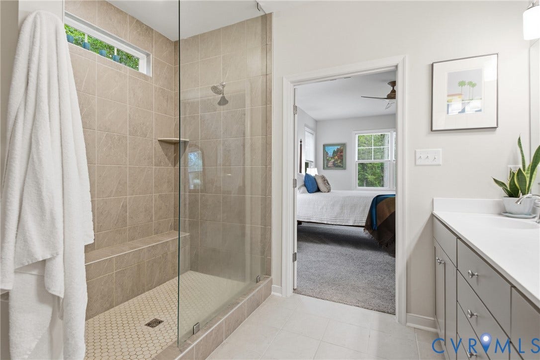 3780 Aston Trail, Powhatan, VA 23139 Glass-enclosed shower with a built-in bench, tiled walls, and a transom window