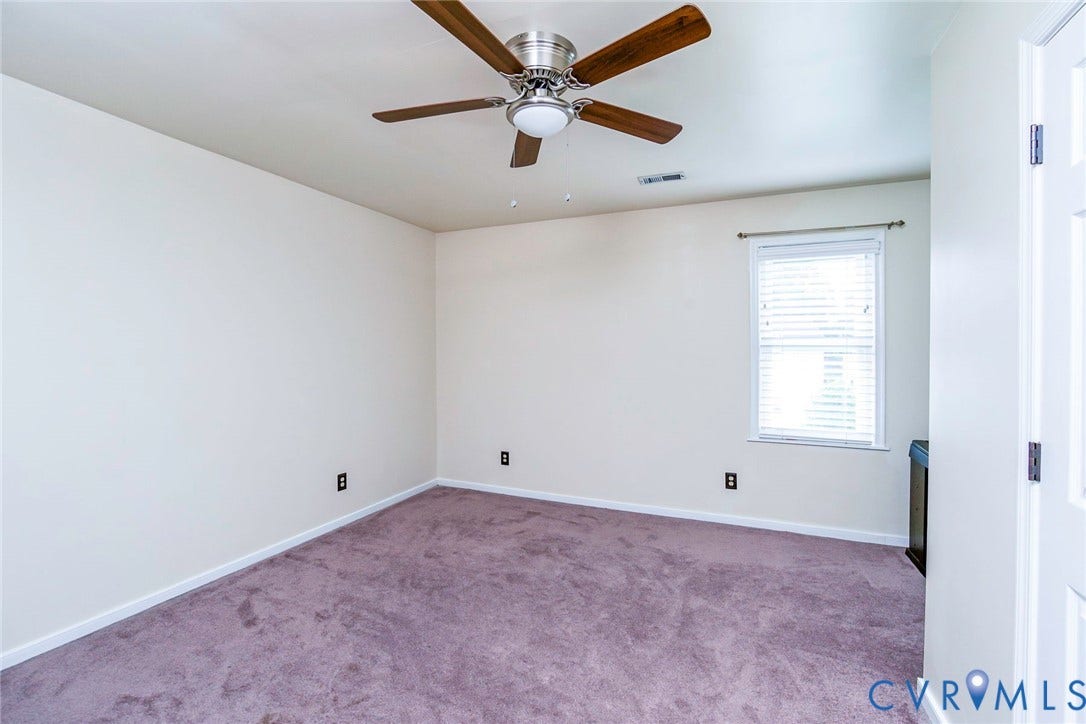 Room featuring plush carpet flooring, a ceiling fan with light fixture, white walls, and a window with blinds