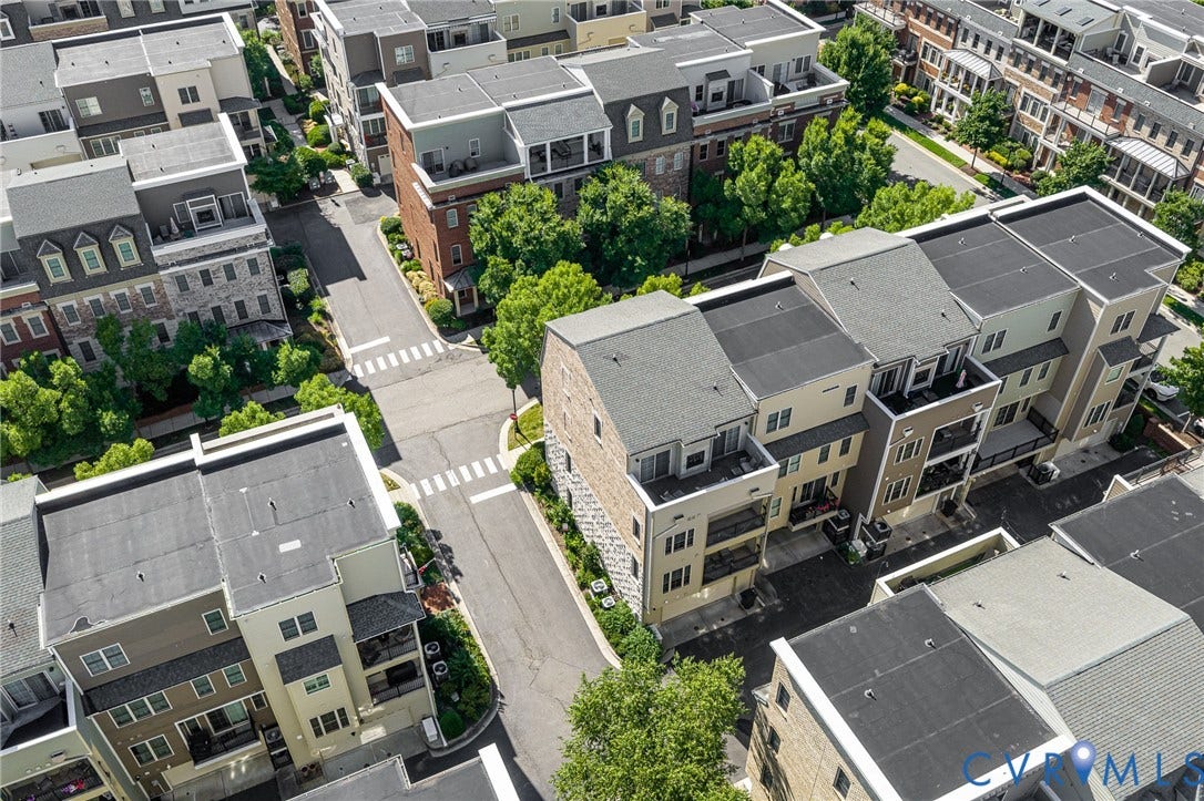 Modern townhome architecture featuring multiple levels, private balconies, and varied rooflines