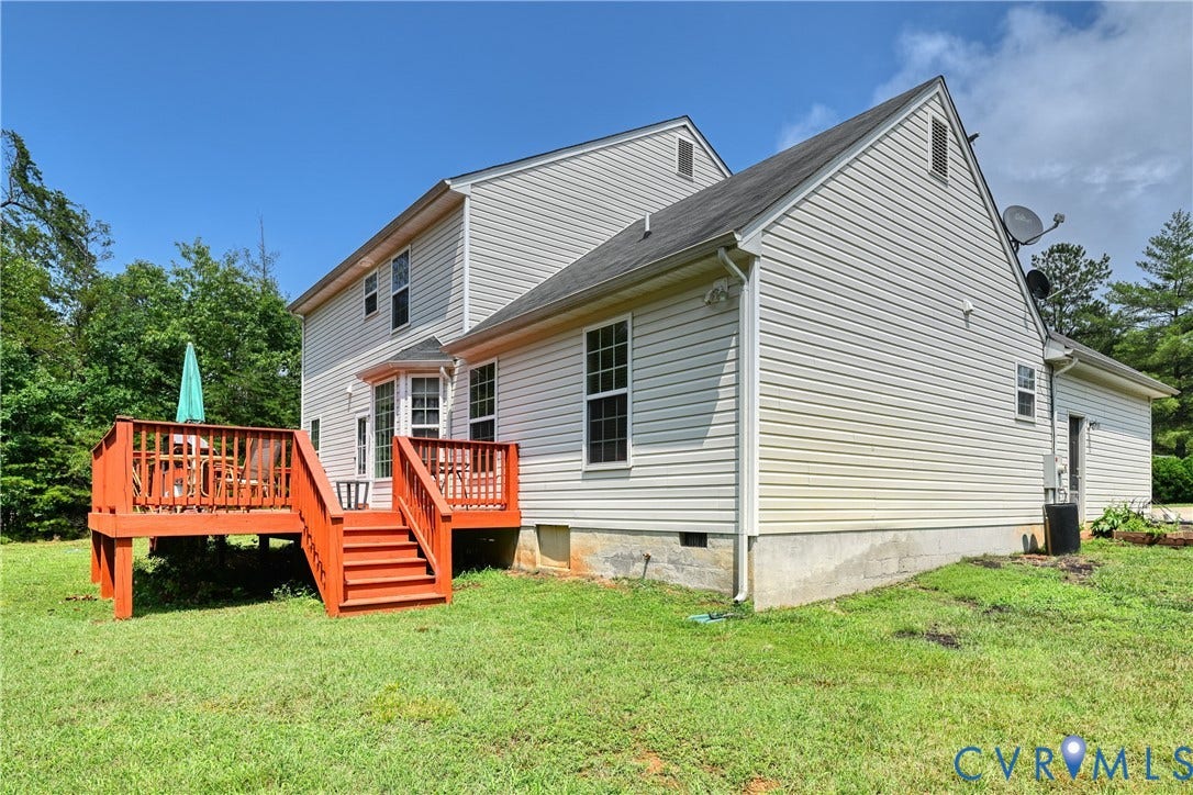 519 N Timber Tribe, Lake Anna, Mineral, VA 23117 Raised wood deck with vibrant red-stained railings and steps, featuring direct access to the home