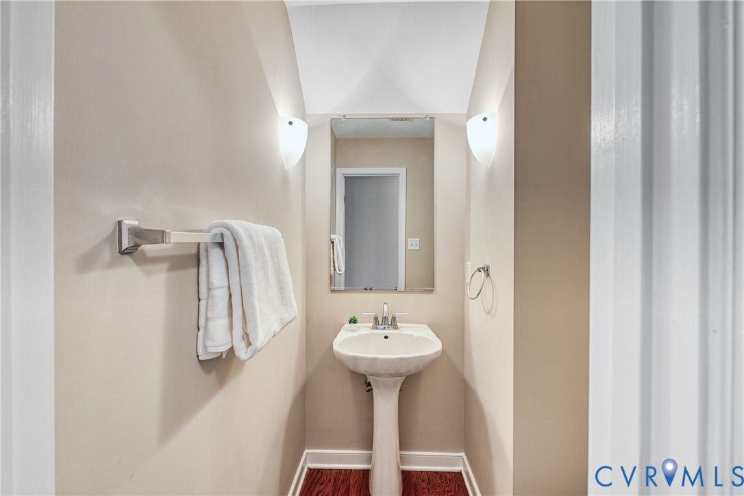 519 N Timber Tribe, Lake Anna, Mineral, VA 23117 Pedestal sink with chrome faucet, complemented by a wall-mounted mirror