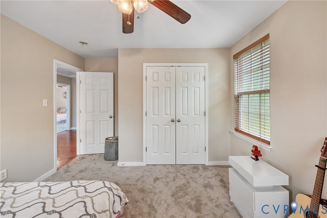 519 N Timber Tribe, Lake Anna, Mineral, VA 23117 New carpet featuring a ceiling fan with integrated lighting, a window with wood blinds