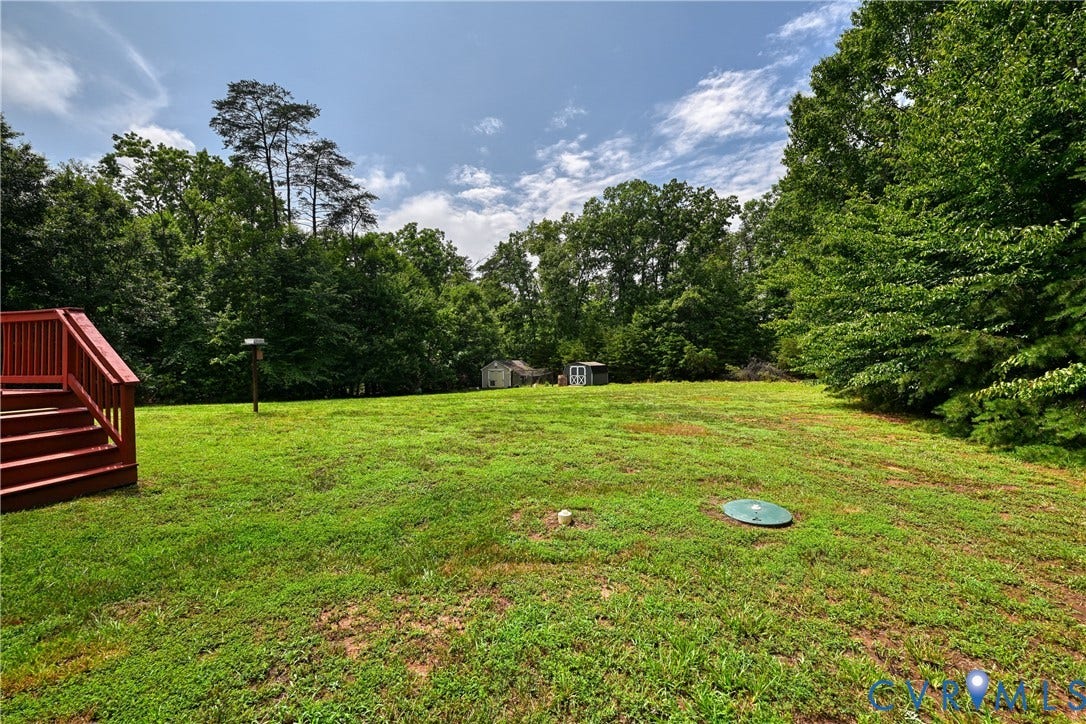 519 N Timber Tribe, Lake Anna, Mineral, VA 23117 Expansive green lawn with mature trees bordering the property
