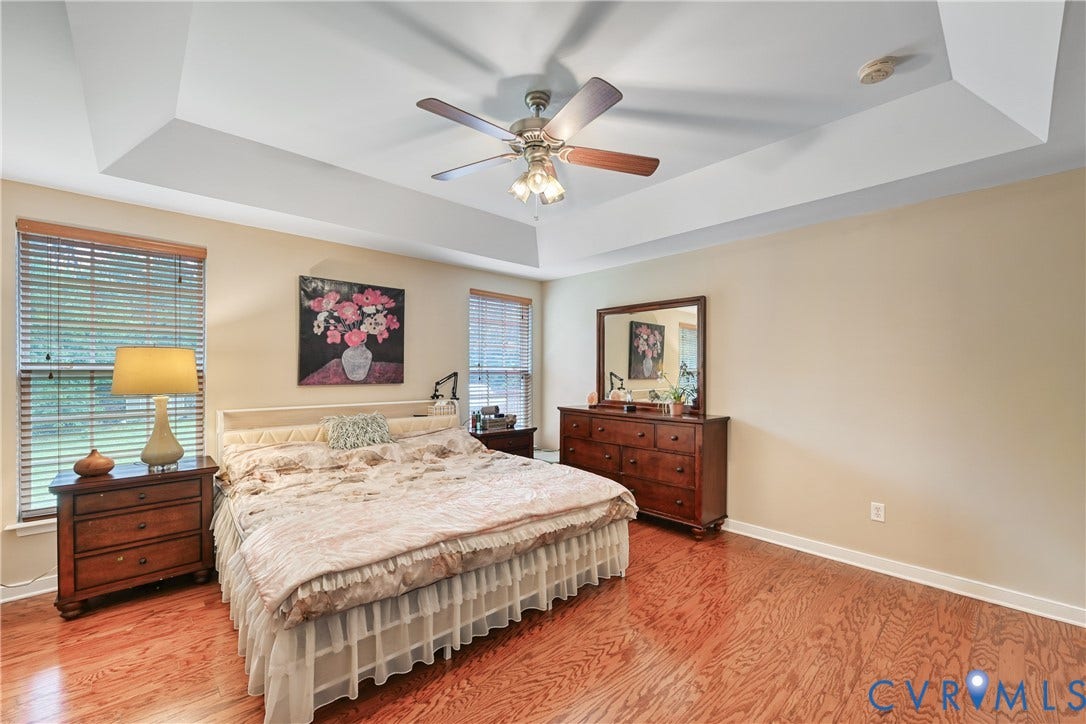 519 N Timber Tribe, Lake Anna, Mineral, VA 23117 Spacious room featuring tray ceilings, wood-finish flooring, and neutral wall tones