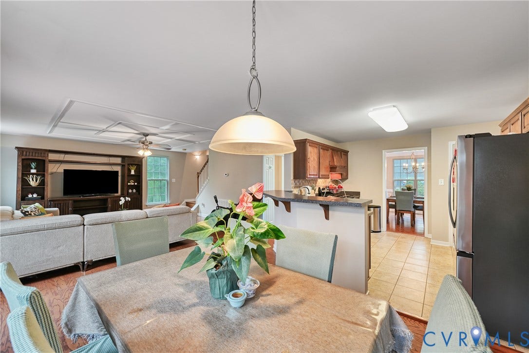 519 N Timber Tribe, Lake Anna, Mineral, VA 23117 Dining area featuring a contemporary pendant light fixture, with a kitchen visible beyond a breakfast bar
