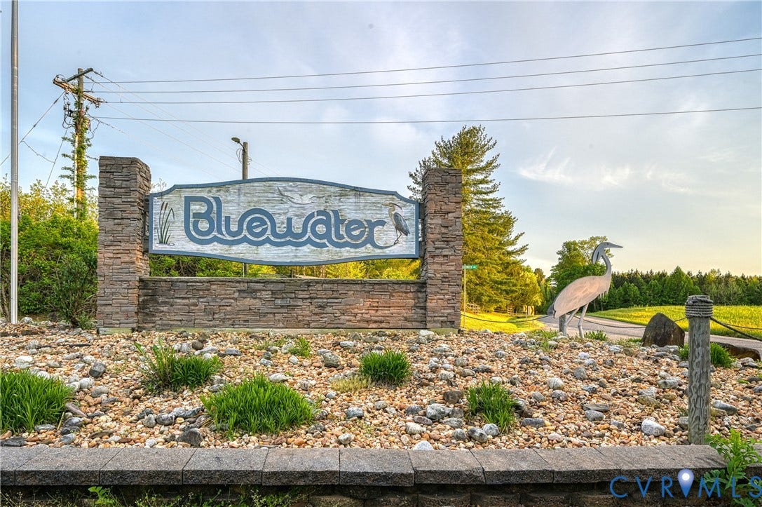 519 N Timber Tribe, Lake Anna, Mineral, VA 23117 Community entrance sign featuring stacked stone columns and base, decorative lettering, and integrated landscaping with gravel and low-growing greenery