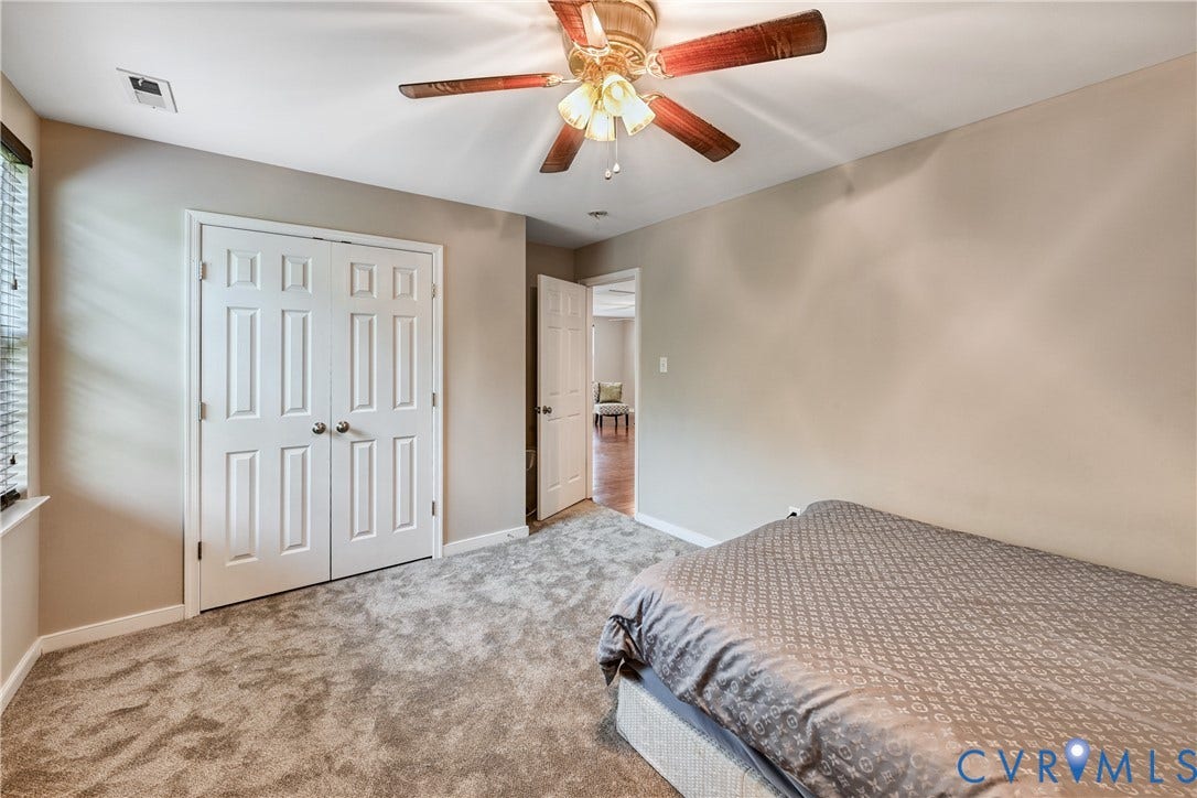 519 N Timber Tribe, Lake Anna, Mineral, VA 23117 Carpeted interior space featuring neutral wall tones, a ceiling fan with integrated lighting, and white paneled doors