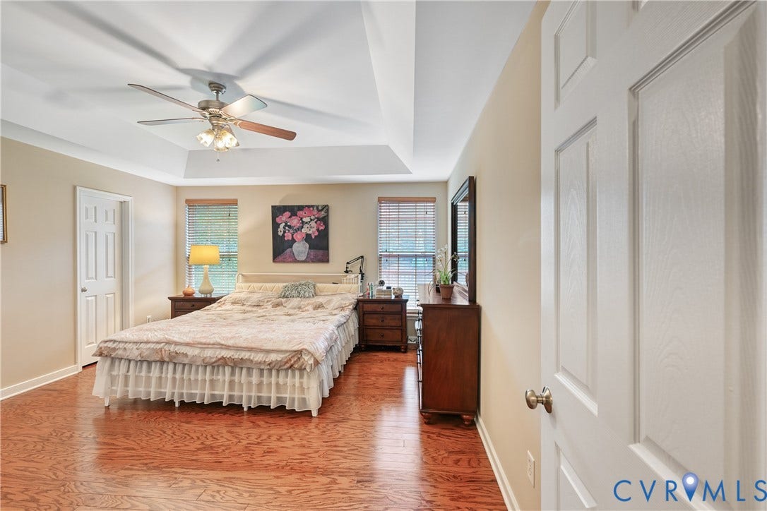 519 N Timber Tribe, Lake Anna, Mineral, VA 23117 Spacious room featuring a tray ceiling, wood-finish flooring, and white paneled doors
