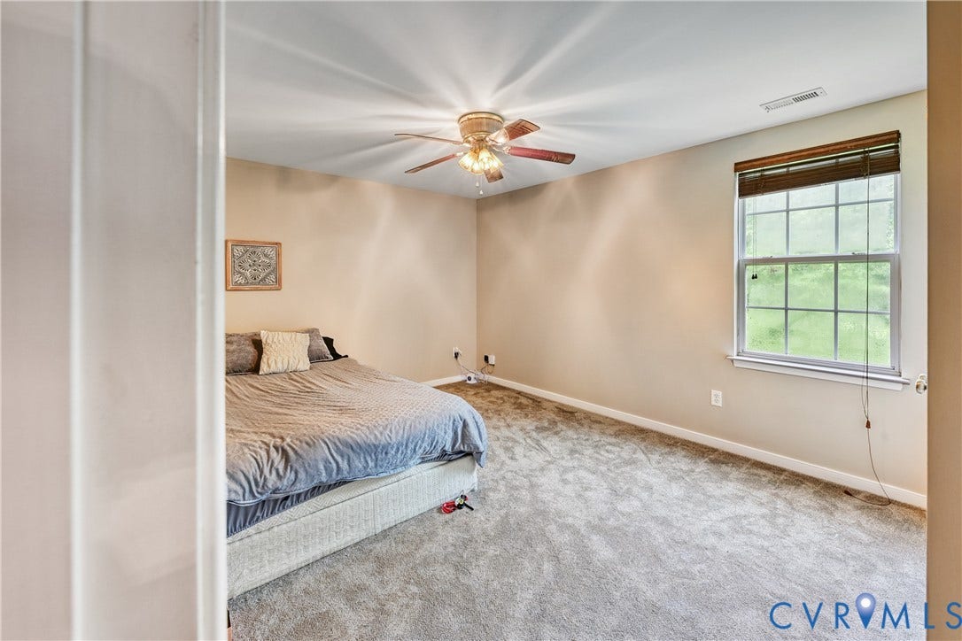 519 N Timber Tribe, Lake Anna, Mineral, VA 23117 Carpeted room featuring a ceiling fan with integrated lighting, a window with blinds, and neutral-toned walls