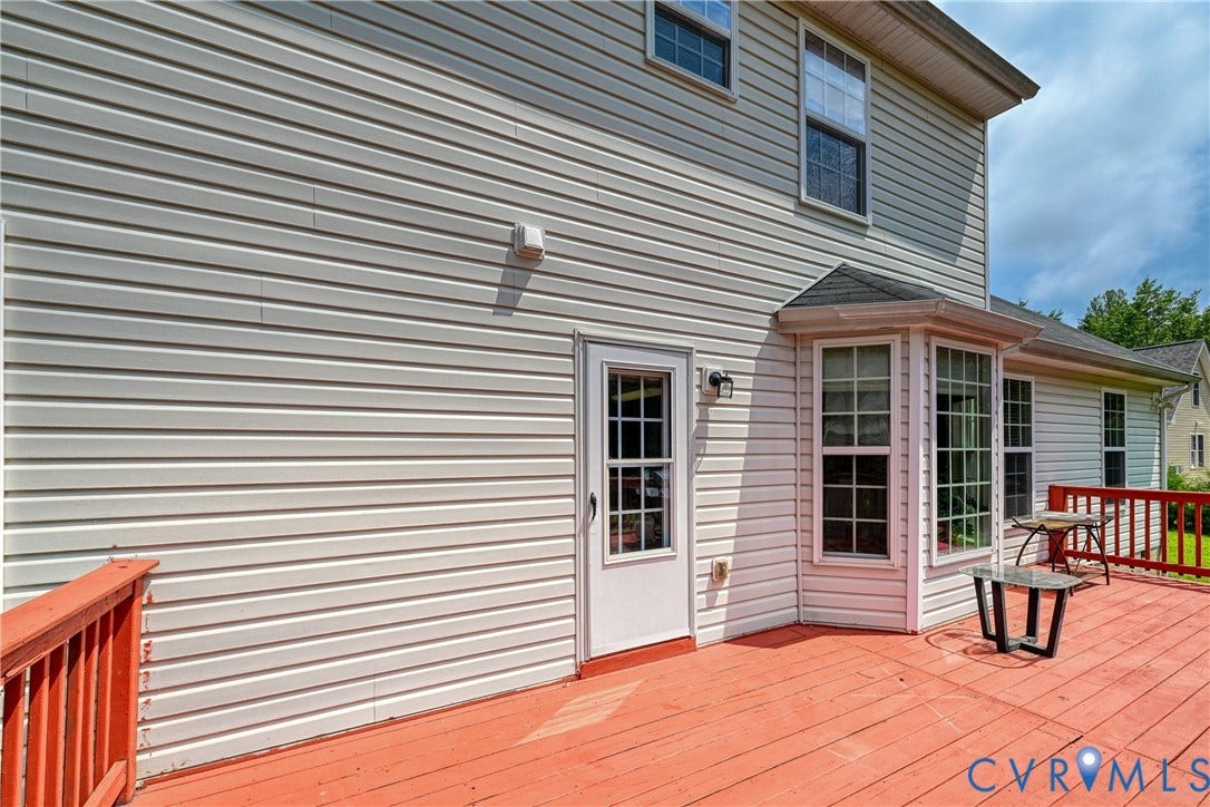 519 N Timber Tribe, Lake Anna, Mineral, VA 23117 Expansive exterior deck featuring a bright red finish, perimeter railing, and direct access door to the main structure
