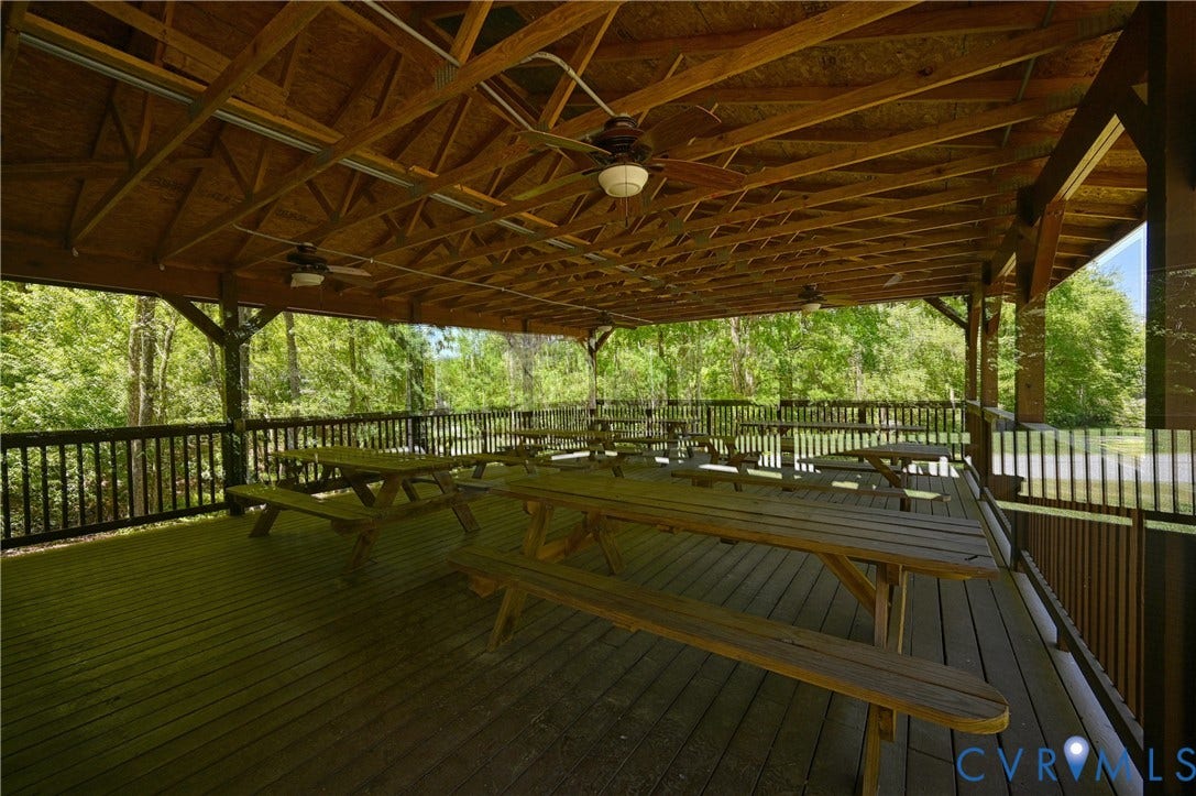 519 N Timber Tribe, Lake Anna, Mineral, VA 23117 Spacious outdoor pavilion featuring a wood-finish ceiling, exposed beam construction, ceiling fans, a wood-finish deck, and black railing