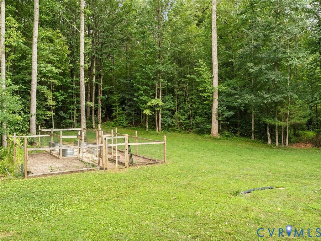 Expansive lawn with a fenced garden area