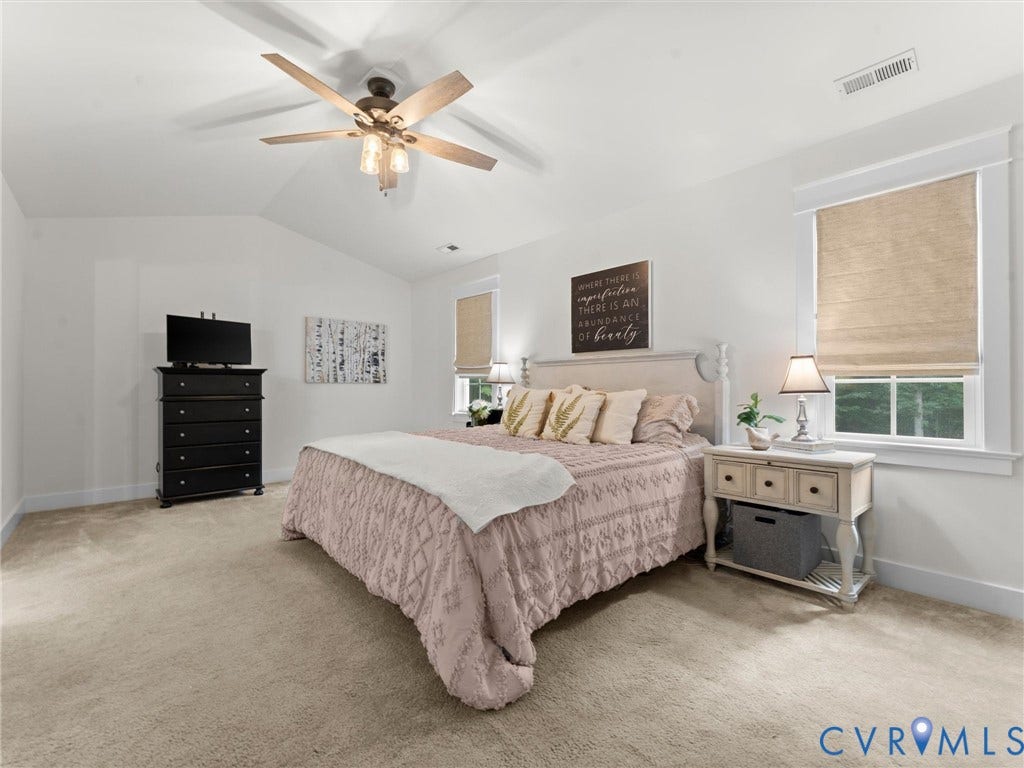 Spacious Primary Suite featuring vaulted ceilings and ensuite bath