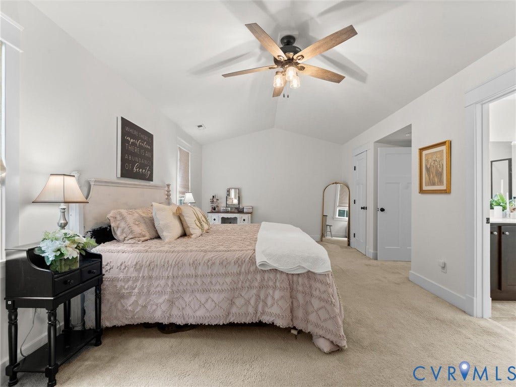 Spacious Primary Suite featuring vaulted ceilings and ensuite bath