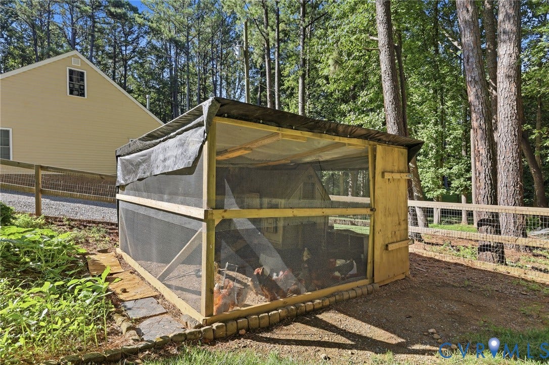 2757 Briarpatch Lane, Powhatan, VA 23139 Outdoor chicken coop with a wood frame and mesh enclosure