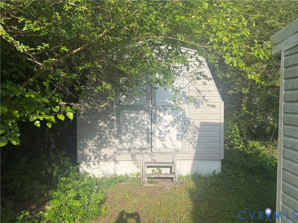 1121 E Booker Circle, Petersburg, VA 23803 White storage shed featuring horizontal siding and double doors