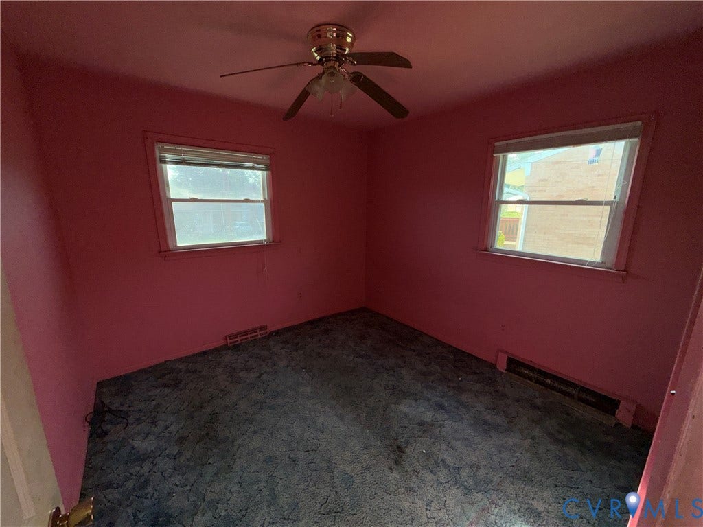 1121 E Booker Circle, Petersburg, VA 23803 Room featuring a ceiling fan with integrated lighting, two windows for natural light, and wall-mounted air vents