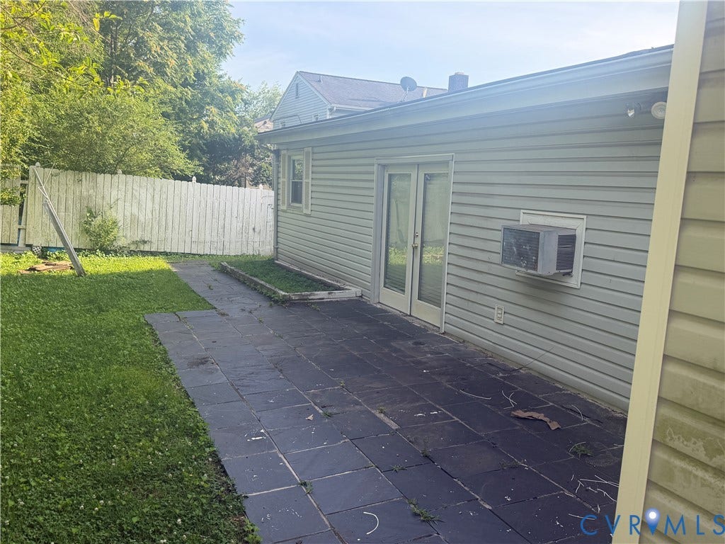 1121 E Booker Circle, Petersburg, VA 23803 Rear exterior featuring light-colored siding, a dark-toned patio, and double glass doors
