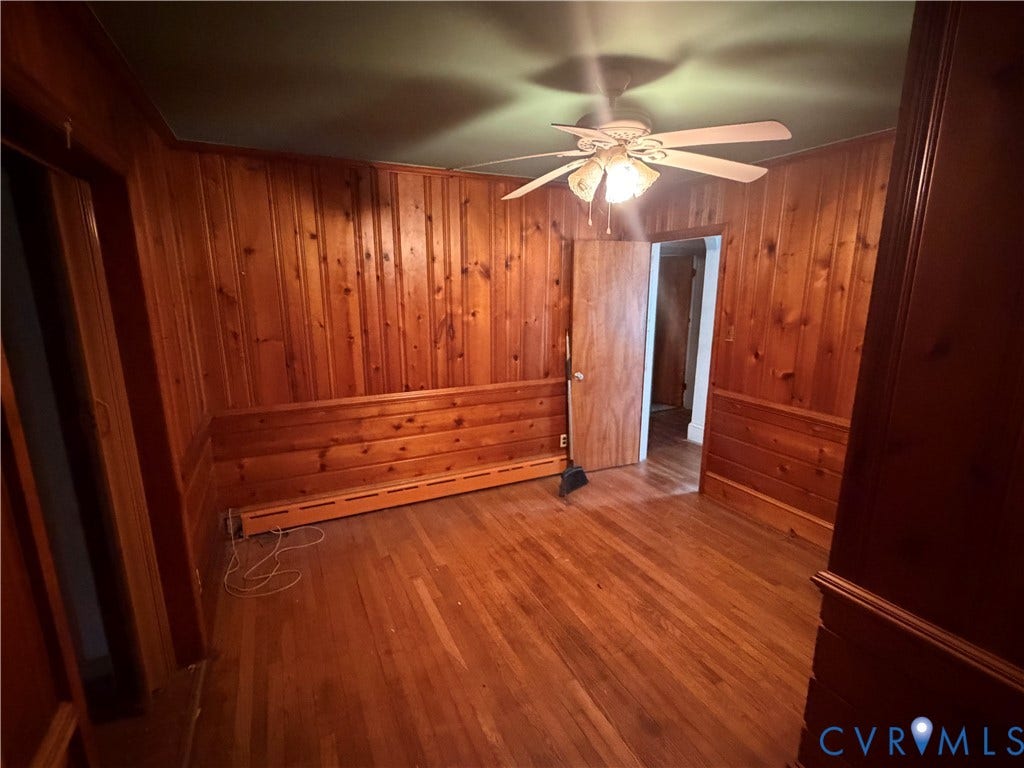3605 Dill Road, Henrico, VA 23222 Room featuring full wood paneling walls, wood-finish flooring, and a ceiling fan with integrated lighting