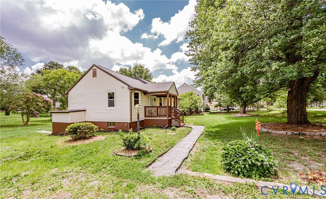 2015 Fordson Road, Richmond, VA 23229 Cream siding exterior with brown trim, featuring a covered porch with wooden railings