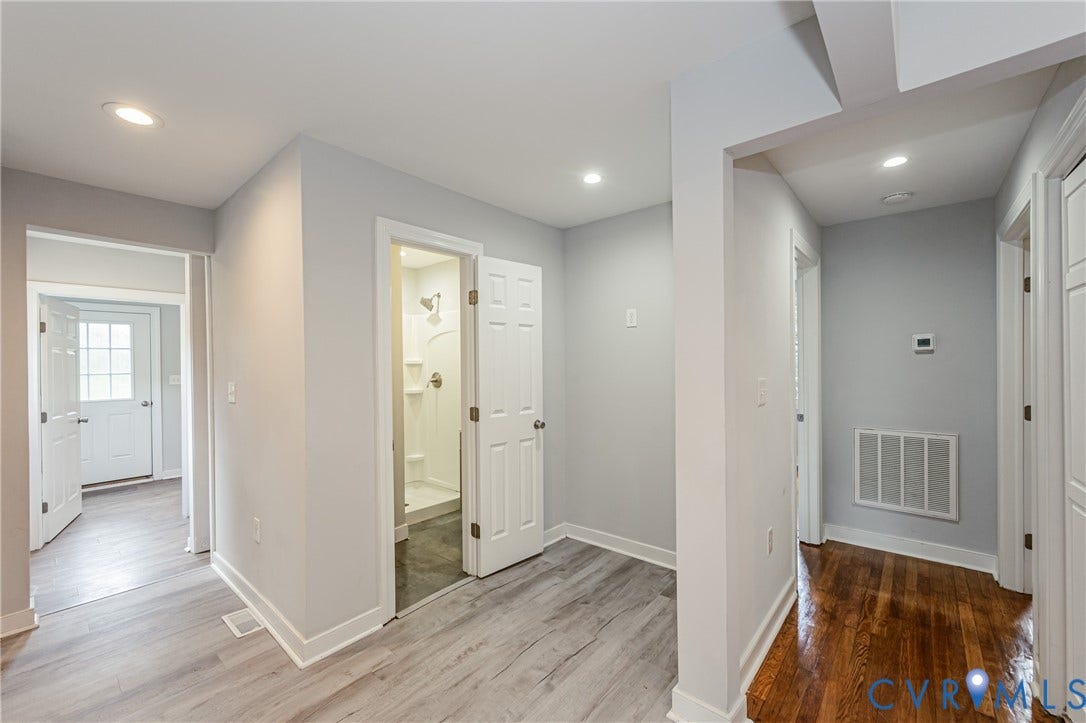 2015 Fordson Road, Richmond, VA 23229 Interior hallway featuring recessed lighting, light wood-finish flooring, a full bathroom with a stand-up shower, and solid wood flooring in an adjoining area