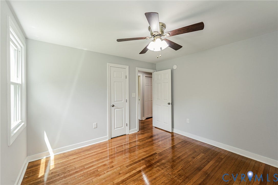 2015 Fordson Road, Richmond, VA 23229 Bedroom featuring hardwood flooring, a ceiling fan with light fixture, and a window with white trim
