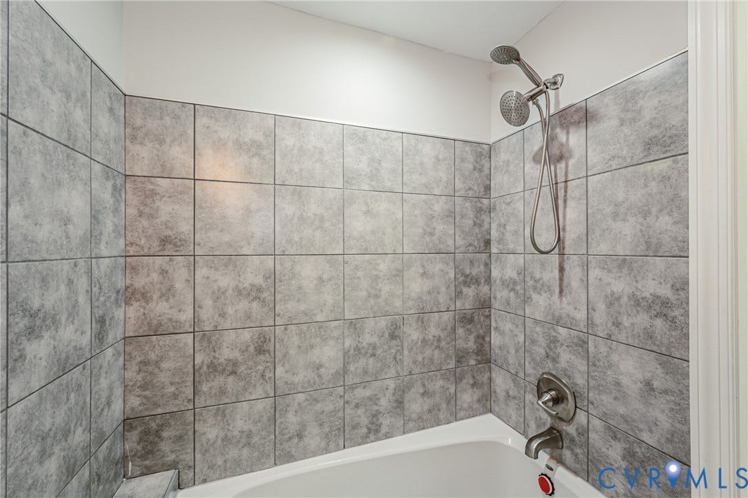 2015 Fordson Road, Richmond, VA 23229 Bathtub shower combination with gray rectangular wall tiles, brushed nickel shower fixtures, and a white tub basin