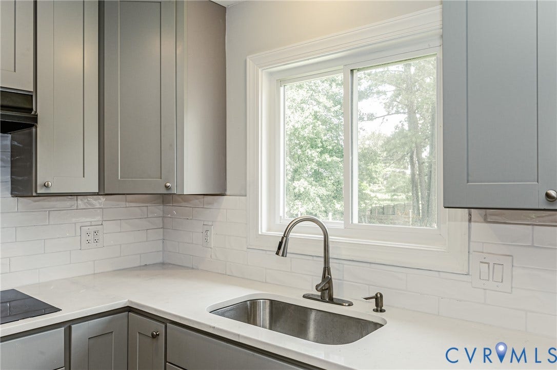 2015 Fordson Road, Richmond, VA 23229 Kitchen featuring a stainless steel sink, brushed nickel faucet, light gray shaker cabinetry, white subway tile backsplash, and light-toned countertops
