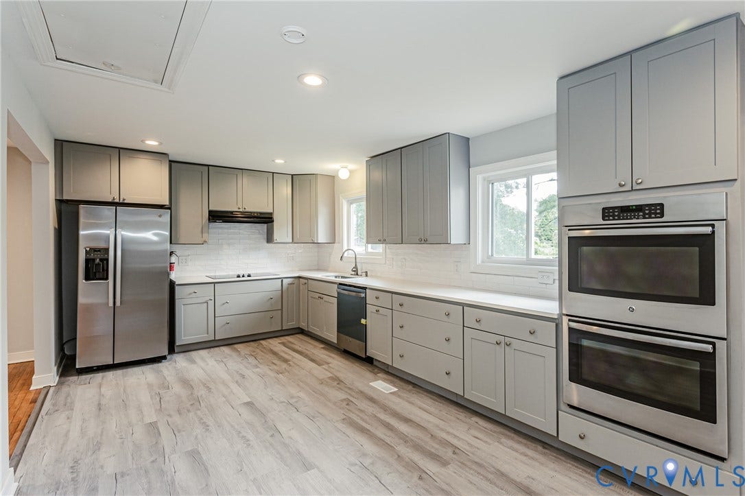2015 Fordson Road, Richmond, VA 23229 Modern kitchen featuring light gray cabinetry, stainless steel appliances, wood-finish flooring, white subway tile backsplash, and recessed lighting