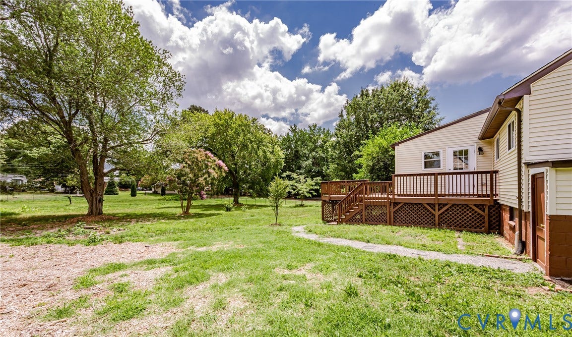 2015 Fordson Road, Richmond, VA 23229 Expansive backyard with a large wood deck featuring stairs and lattice skirting