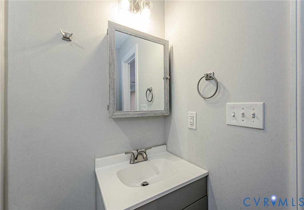 2015 Fordson Road, Richmond, VA 23229 Bathroom vanity featuring a single basin, gray base cabinet, and light gray countertop