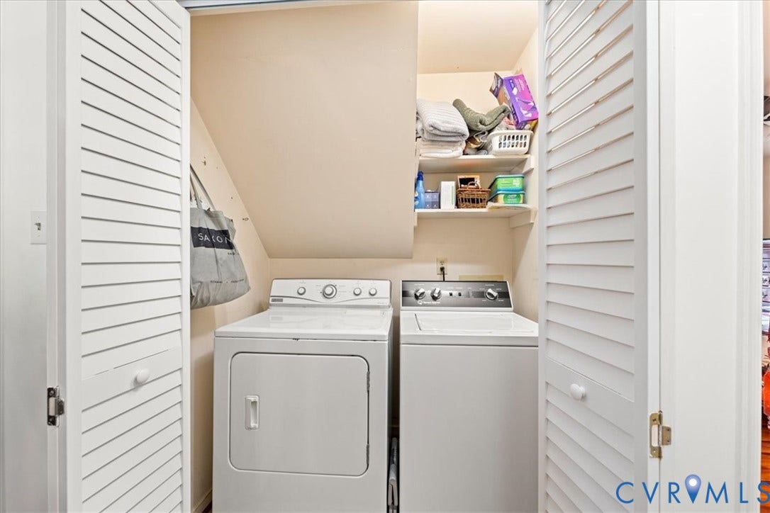Dedicated laundry area featuring bi-fold louvered doors
