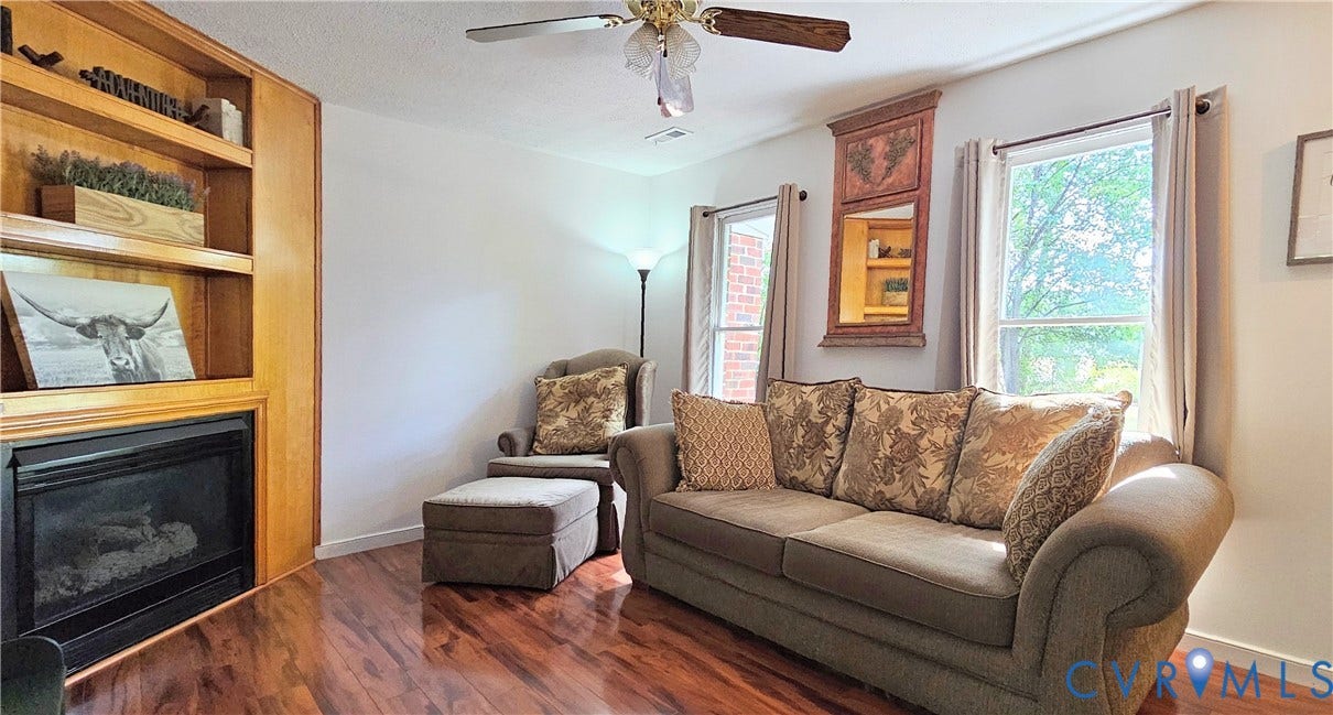 Hardwood-finish flooring complementing the built-in shelving unit with an integrated fireplace