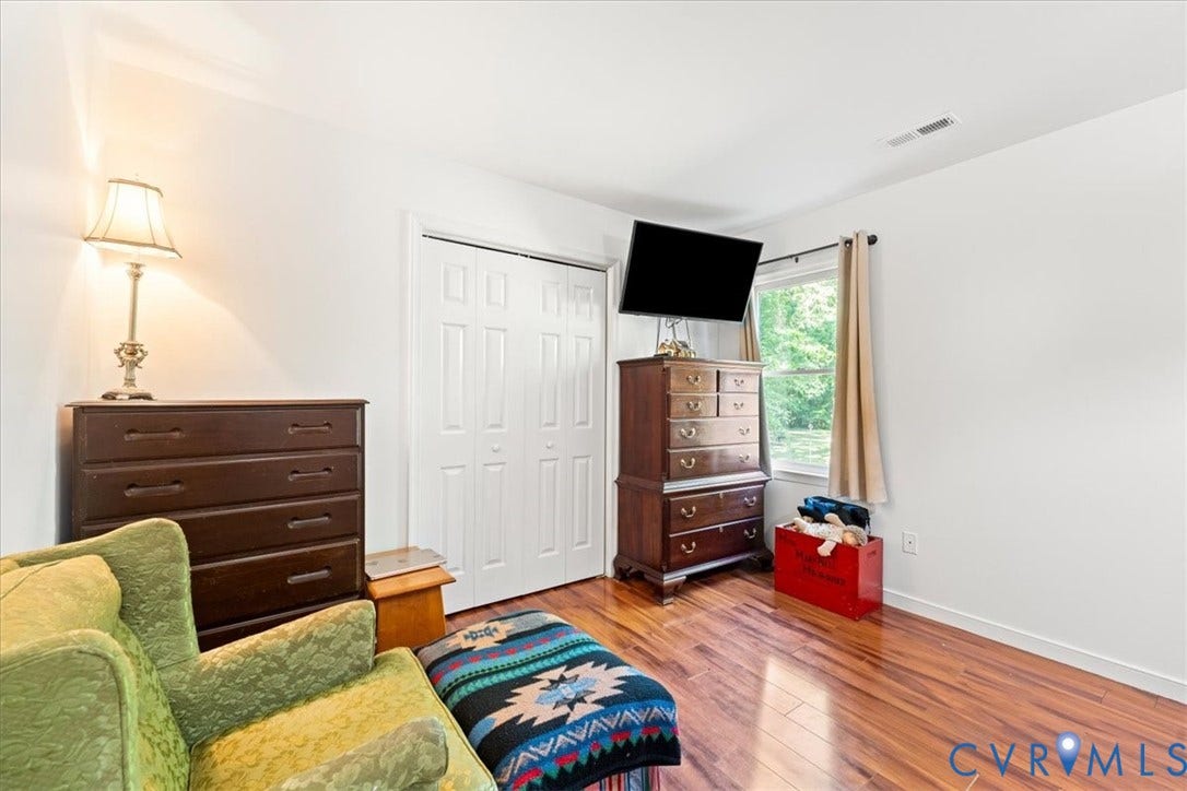 Laminate wood-finish flooring complements the room's white walls