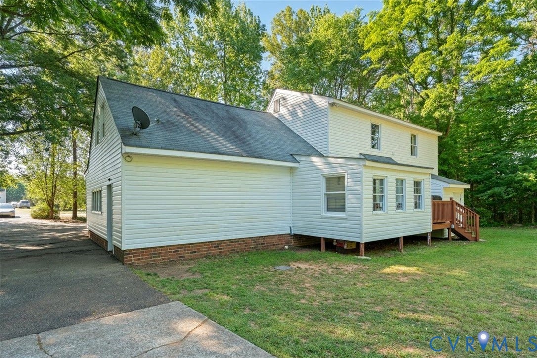 Two-story residence featuring white siding and a brick foundation